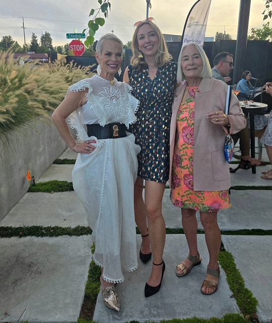 three women smiling outdoors