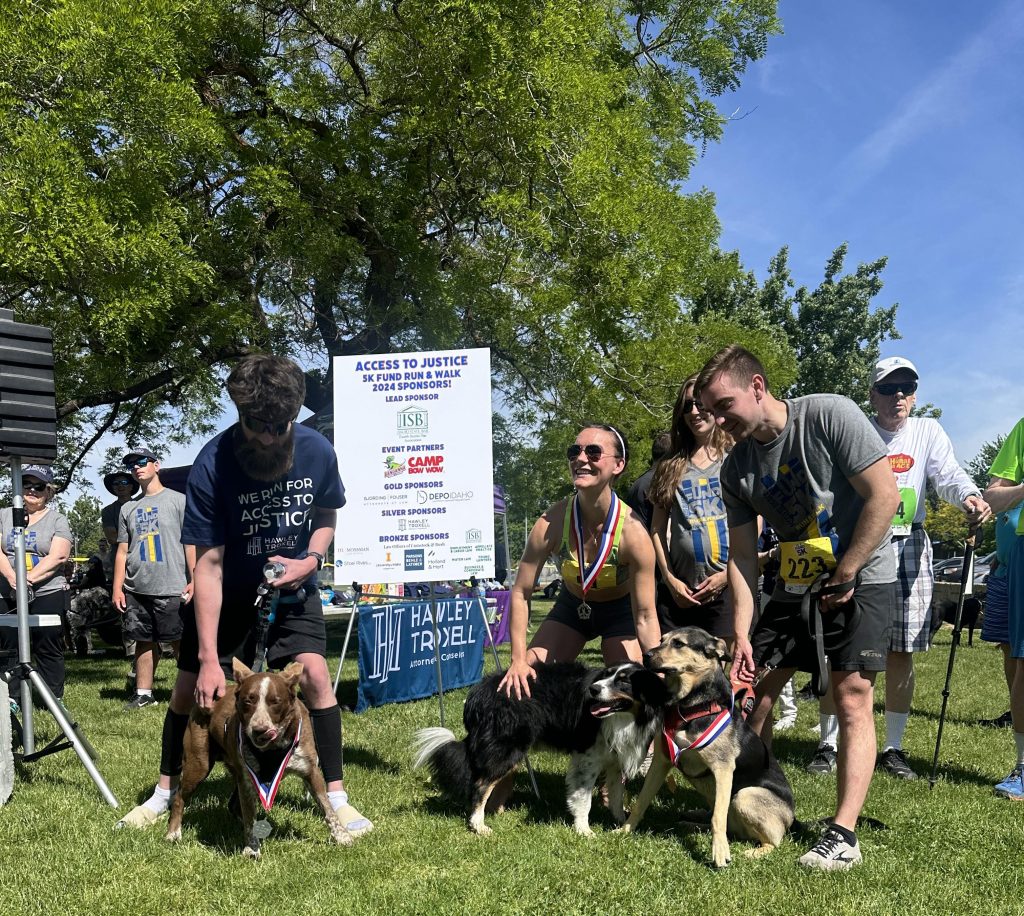 Winners of the Fund Run 2024 pose with their dogs.