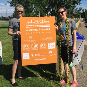 Participants of the 2016 Fund Run pose with the sponsor board.